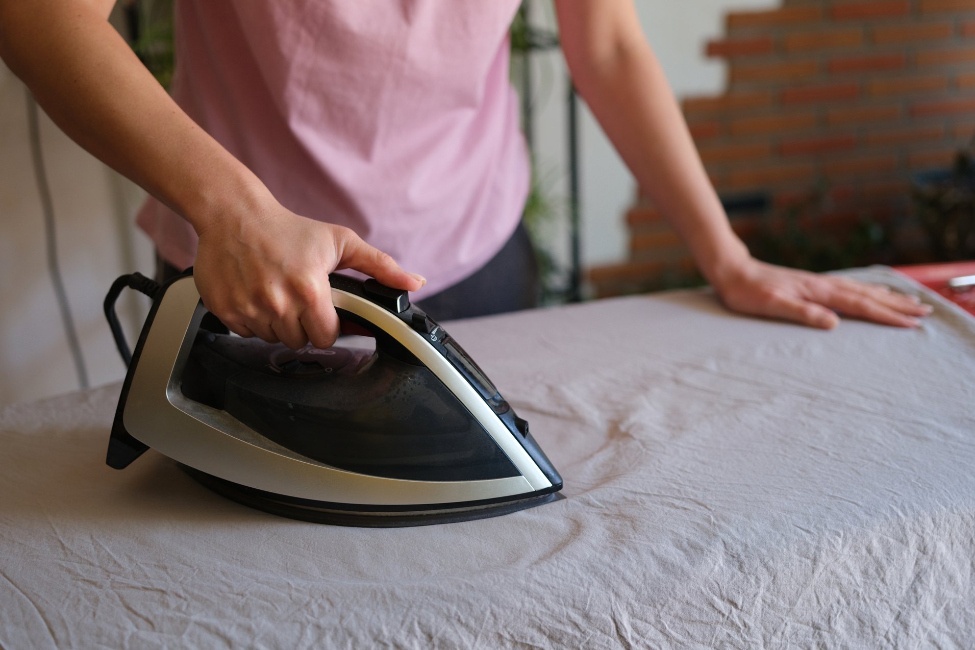 Girl Holds Iron on Ironing Board and Irons Things